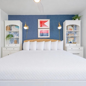 Guest bedroom featuring a plush king bed, stylish decor, and elegant shelving for a cozy retreat