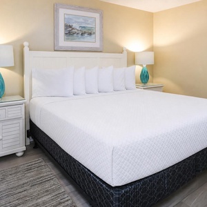 Unwind in this serene bedroom featuring a king bed, stylish decor, and soft lighting for a restful night