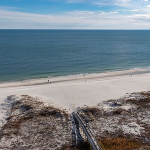 Impressive view of the beach with soft white sand and gentle waves, inviting relaxation and beachside strolls