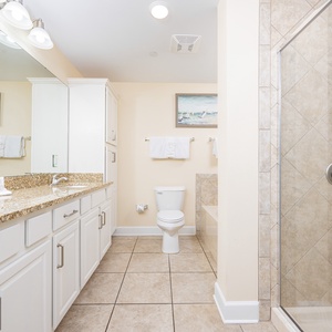 Indulge in refreshing moments after a beach day in the master bath featuring a refreshing shower and jetted tub