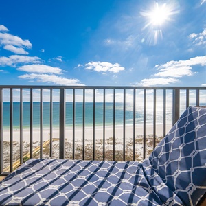 Relax on the lounge chair while soaking in the stunning views of the sparkling water and bright blue skies