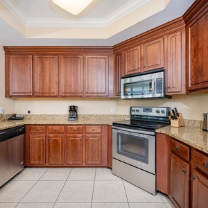 Modern kitchen featuring stainless appliances, rich wood cabinetry, and granite countertops for a stylish cooking experience