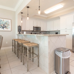 Enjoy casual chats at the breakfast bar while sipping coffee, immersed in relaxing beach vibes