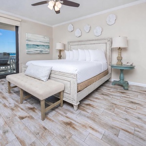 Unwind in this serene master suite featuring a plush king bed, stylish decor, and beachfront balcony access