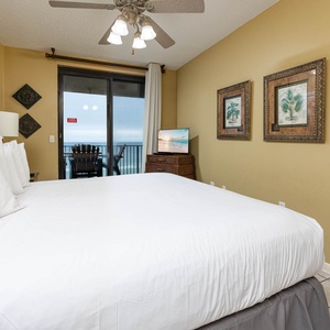 Experience restful nights in the master bedroom with a king bed, a TV, and access to the beachfront balcony