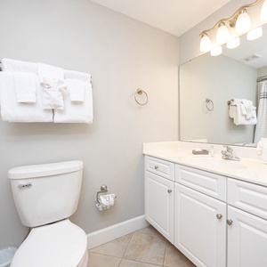 Freshen up in this guest bath in the relaxing shower or soothing tub before an exciting day