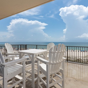 Relax on the extra-large balcony with white Adirondack chairs, enjoying the beautiful beach view and gentle sea breeze