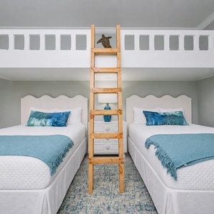 Enjoy a unique sleeping arrangement with two loft twin beds and two charming queens below with a wooden ladder