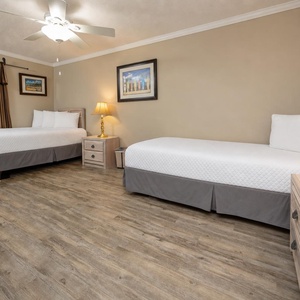 Your guest suite with a double and a twin bed offers restful nights paired with warm lamp glow and gentle ceiling fan breezes