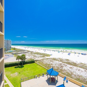 Imagine afternoons spent watching kids play volleyball while the shore stretches wide beneath clear blue skies