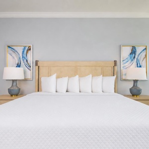Experience restful nights in this inviting master with a king bed, stylish decor, and soft lighting