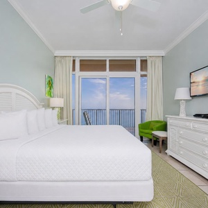 Feel the calm as you watch waves from your balcony in this cozy master suite