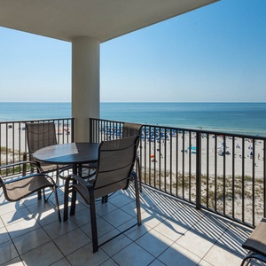 Enjoy stunning views from the balcony, complete with a dining table and chairs overlooking the pristine beach