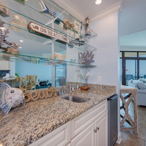 Sip your favorite drink at the wet bar, surrounded by beach decor, while enjoying coastal views