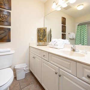 Experience effortless mornings in this guest bath, complete with plush towels, preparing for another beach day
