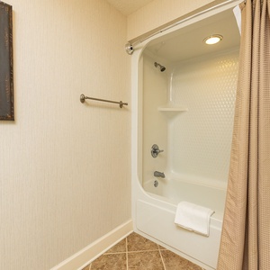 Refresh in the guest bath featuring a tub/shower combo, plush towels, and a well-lit space for your comfort