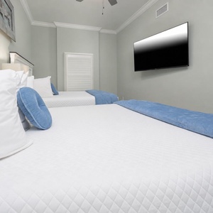 Rest on inviting bedding in this queen guest suite and watch shows on the TV after beach time