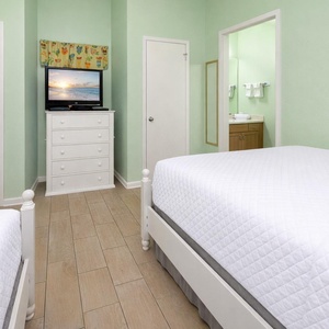 Unwind in this guest room with two beds, a TV, and a vibrant coastal decor for a relaxing stay