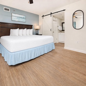Relax in this inviting master bedroom featuring a king bed, stylish decor, and easy access to the master bath