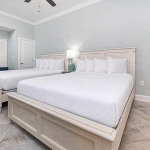 Read beside the nightstand lamp and rest in the two roomy queen beds in this guest suite
