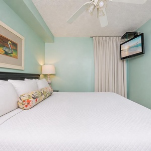 Fluffy pillows invite you to relax in the king suite for a calm movie night after a fun day at the beach