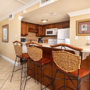 The kitchen features stylish cabinetry, modern appliances, and a cozy breakfast bar for a delightful cooking experience