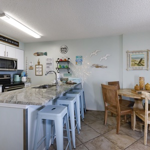 The kitchen features granite countertops, stainless appliances, and a cozy dining area, perfect for enjoying meals together