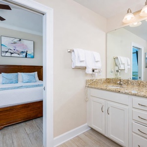 A granite vanity gleams in the guest bath where you prepare for a day of coastal fun