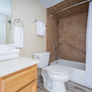 Refreshing master bathroom featuring a tub/shower combo, fresh towels, and modern finishes for a relaxing retreat