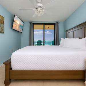 Drift into dreamland in this king master suite as sunlight spills through the glass doors, beckoning you to the coast