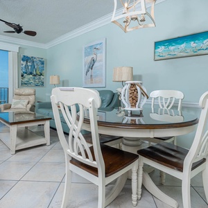 Dine at the round table, surrounded by beach decor and inviting seating for a relaxing meal together