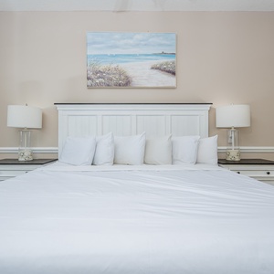 Rest comfortably in the master bedroom featuring a king bed, elegant decor, and soft lighting for a relaxing atmosphere