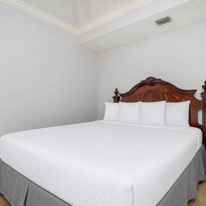 Drift into a restful slumber in this queen guest suite enveloped by fluffy bedding and plush pillows