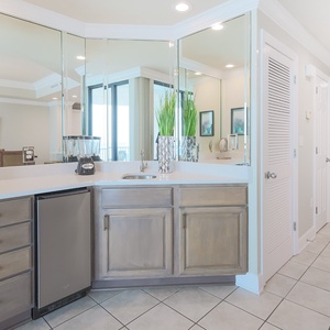 Prepare drinks at the stylish wet bar, featuring an ice maker and a blender, perfect for entertaining guests