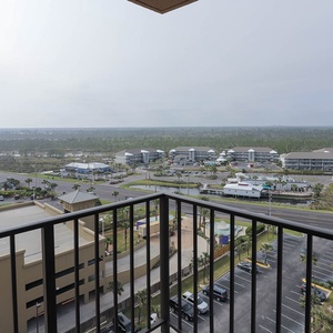 Experience breathtaking views from the balcony, overlooking lush greenery and vibrant surroundings, perfect for relaxation