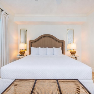 Sleep soundly in the soft, fluffy king bed while soft lighting fills the room, enhancing your restful escape