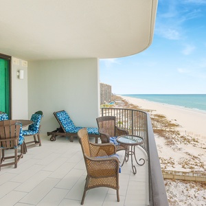 Relax on the spacious balcony with comfortable seating, perfect for enjoying the coastal views and fresh air
