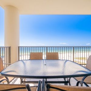 Enjoy meals on the balcony with a stunning view of the beach and tranquil waters beyond
