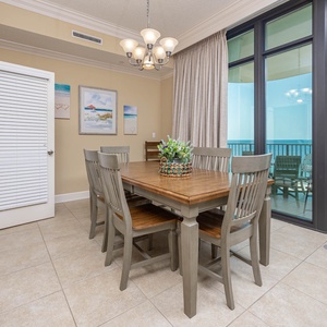 Gather around the dining table, sharing stories while soaking in the coastal views from the balcony