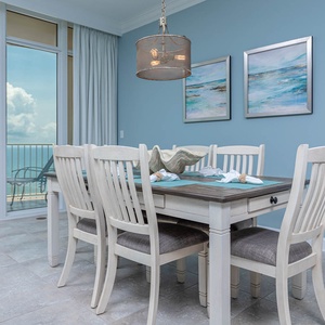 Gather around the spacious dining table, enjoying laughter and conversation with views of the inviting coast