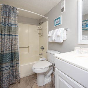 Master bath featuring a spacious vanity, fresh towels, and a shower/tub combo for a refreshing experience