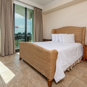 Rest in the plush double bed in this guest suite, where soft linens and balcony light create a calming space