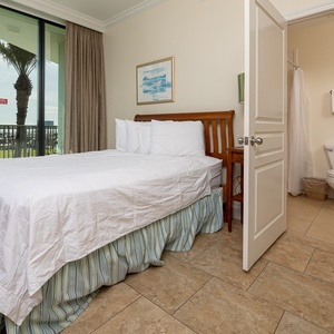 Embrace comfort in the cozy double bed, feeling refreshed with soft linens and inviting views of the bay