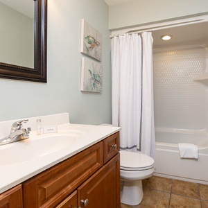Freshen up in this guest bath in the relaxing shower or soothing tub before an exciting beach day