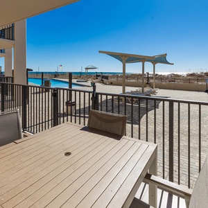 Relax on the ground floor patio with views of the gradual entry pool area and a glimpse of the beach beyond