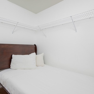 Additional twin bed in closet of the master bedroom for additional sleeping arrangements