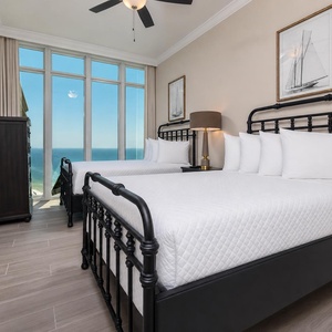 Wake to a breathtaking sunrise in this guest suite with two cozy double beds and expansive views from the windows