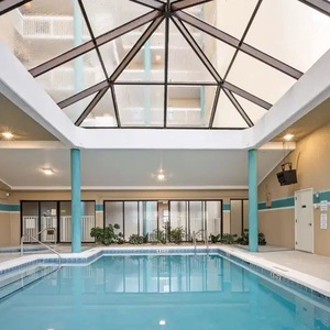 Relax by the indoor pool surrounded by greenery and natural light at Romar Place in Orange Beach