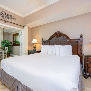 Embrace relaxation in the plush king bed, with gentle lighting and coastal decor setting a serene vibe in the master