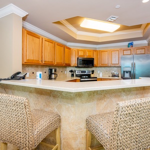 Enjoy morning coffee at the stylish breakfast bar while savoring delicious family conversations in this cozy kitchen